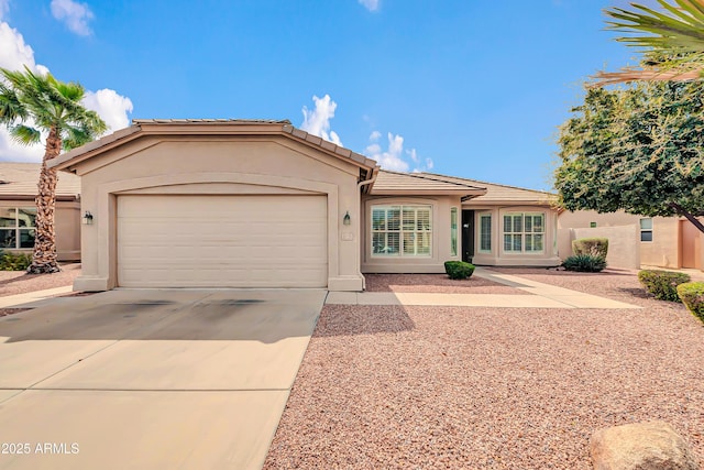 single story home featuring stucco siding, a tiled roof, an attached garage, and driveway