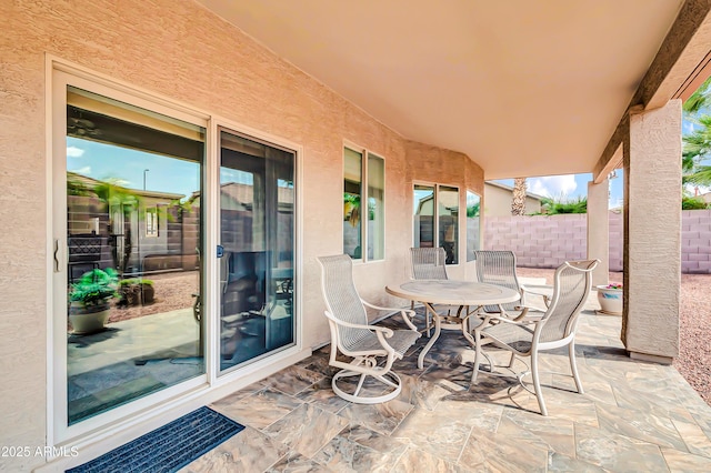 view of patio / terrace featuring outdoor dining area and fence