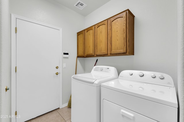 clothes washing area with cabinet space, visible vents, independent washer and dryer, and light tile patterned floors