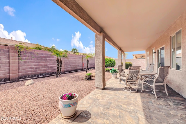 view of patio with outdoor dining area and a fenced backyard