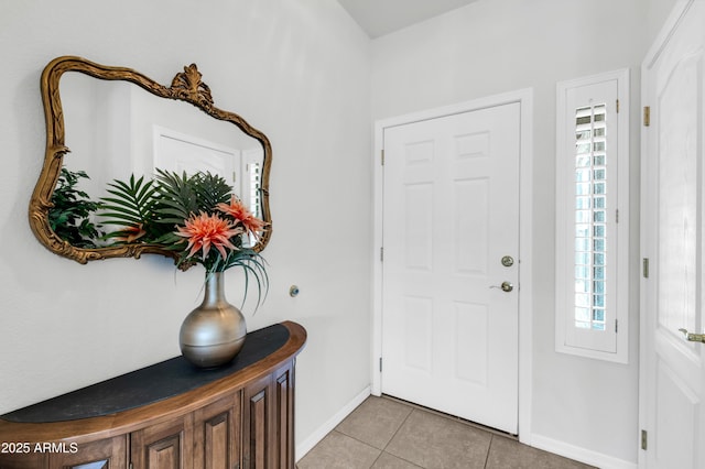 foyer with light tile patterned floors and baseboards