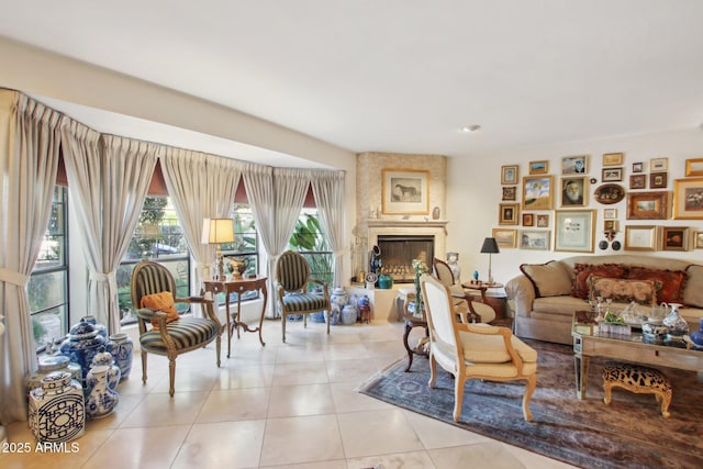 living room featuring a large fireplace and light tile patterned flooring