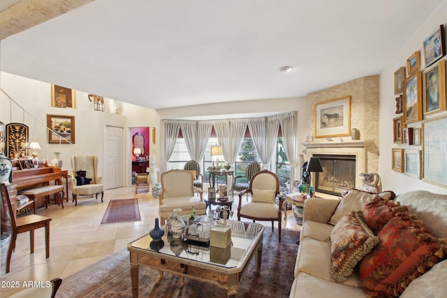 living area with a large fireplace and light tile patterned flooring