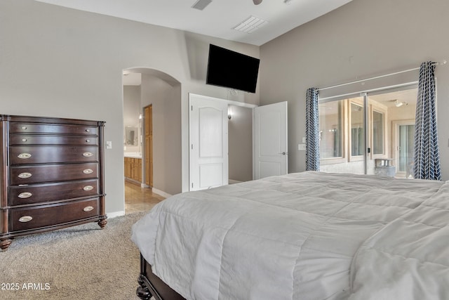 43271 W Little Dr, Maricopa, AZ 85138 - carpeted bedroom featuring arched walkways, access to exterior, baseboards, and ensuite bathroom