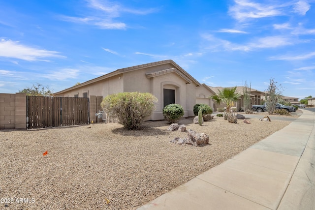 43271 W Little Dr, Maricopa, AZ 85138 - view of front facade with stucco siding and a gate
