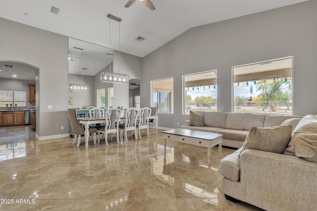 43271 W Little Dr, Maricopa, AZ 85138 - living room featuring arched walkways, plenty of natural light, and marble finish floor