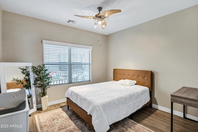 bedroom with hardwood / wood-style flooring and ceiling fan