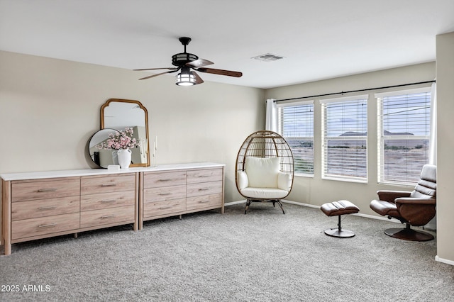 sitting room featuring carpet and ceiling fan