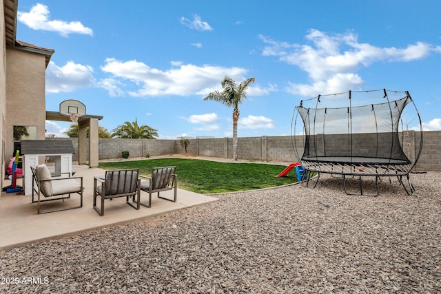 view of yard with a patio and a trampoline