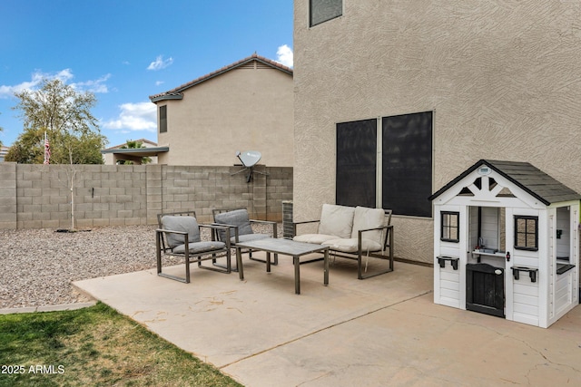 view of patio with an outdoor living space and an outdoor structure