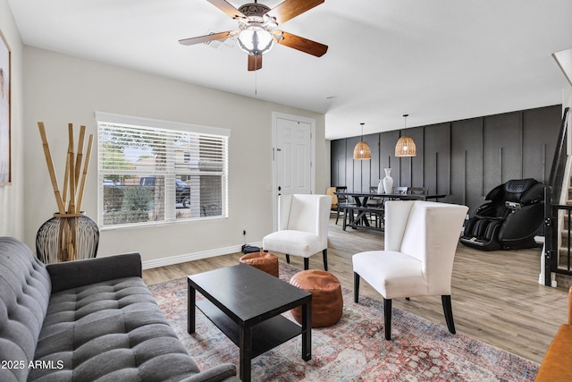 living room featuring ceiling fan and light hardwood / wood-style floors