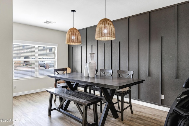 dining space with light hardwood / wood-style floors