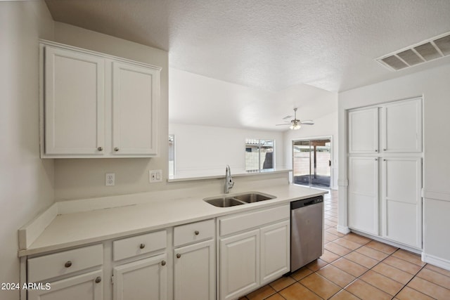 kitchen featuring white cabinets, a textured ceiling, ceiling fan, stainless steel dishwasher, and sink