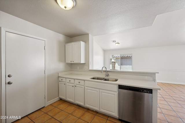 kitchen featuring white cabinetry, sink, light tile patterned flooring, and stainless steel dishwasher