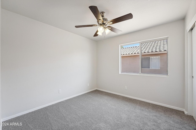 spare room featuring carpet and ceiling fan