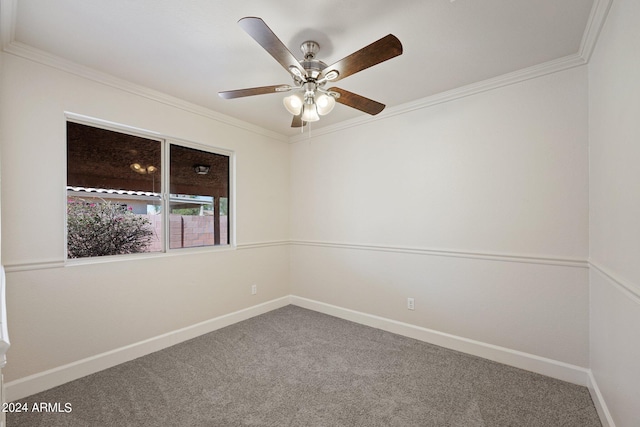 unfurnished room with ornamental molding, carpet, and ceiling fan