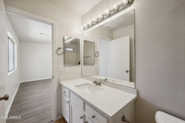 bathroom featuring hardwood / wood-style flooring, vanity, and toilet