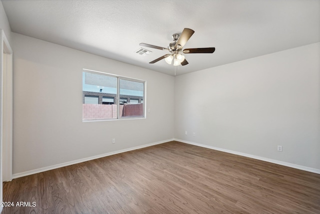 unfurnished room with ceiling fan and hardwood / wood-style flooring