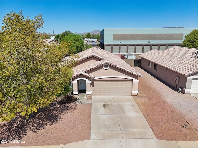 view of front of home with a garage and a mountain view