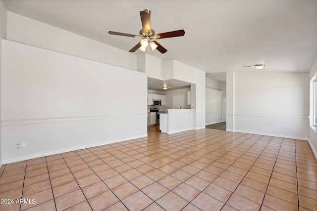 unfurnished living room featuring ceiling fan and light tile patterned floors