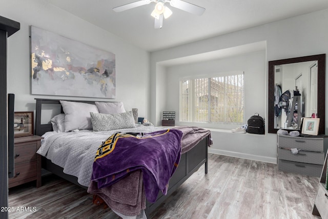 bedroom with ceiling fan and hardwood / wood-style floors