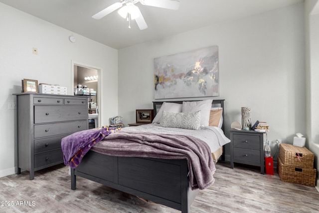 bedroom with connected bathroom, light hardwood / wood-style flooring, and ceiling fan