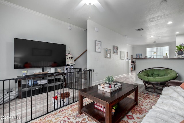 living room with ornamental molding and light wood-type flooring