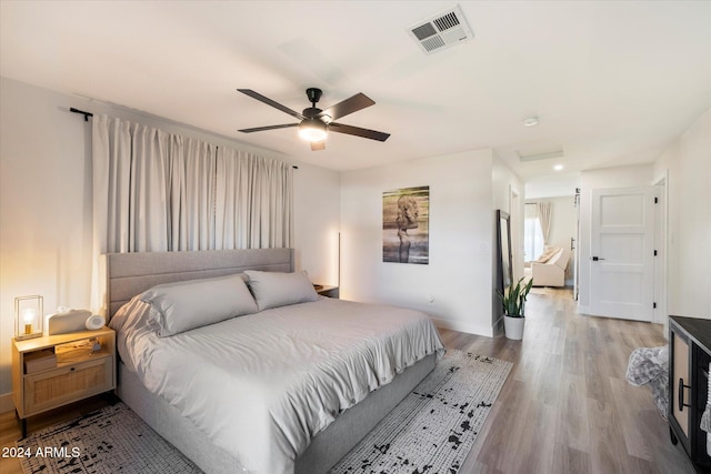 bedroom with ceiling fan and light hardwood / wood-style flooring