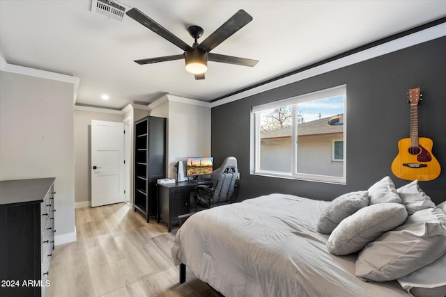 bedroom featuring ceiling fan, light hardwood / wood-style flooring, and ornamental molding