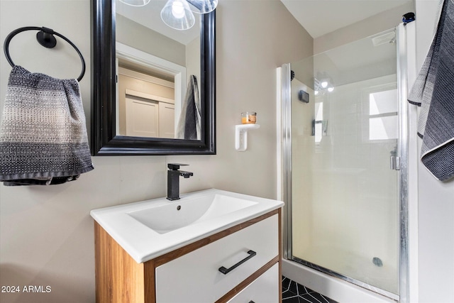 bathroom featuring vanity and a shower with door