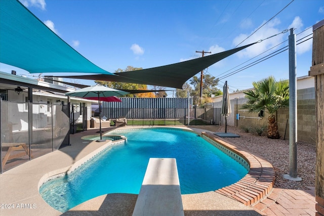 view of pool with a diving board and a patio