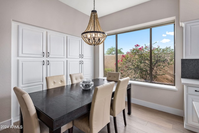 dining room with a chandelier and light wood-type flooring