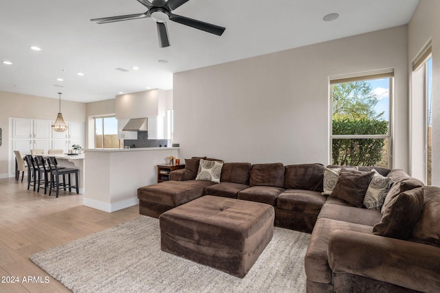 living room featuring ceiling fan and light hardwood / wood-style flooring