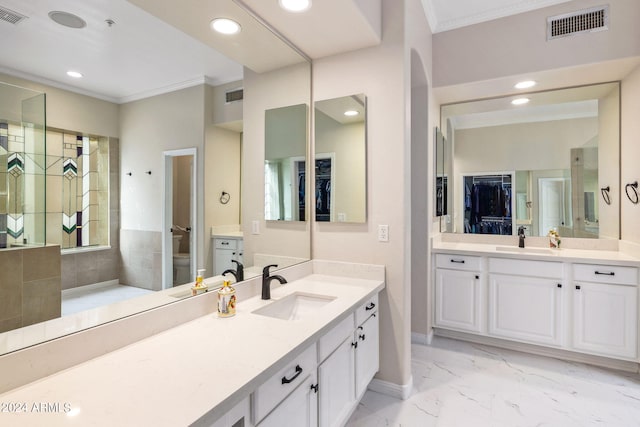 bathroom with crown molding, vanity, and tile patterned floors