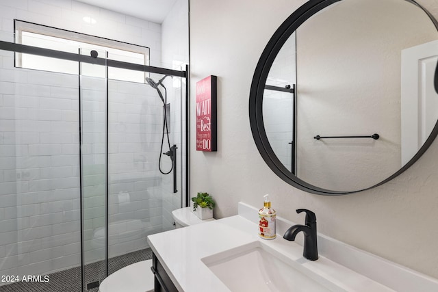 bathroom with a shower with shower door, toilet, and vanity