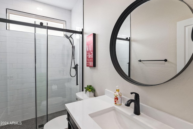 full bath with toilet, vanity, and a shower stall