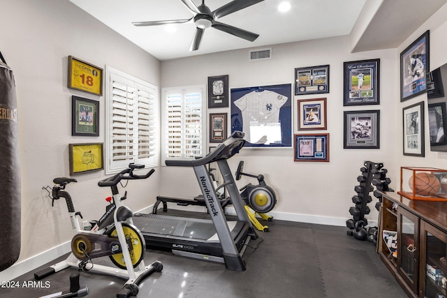 workout area featuring baseboards, ceiling fan, and visible vents