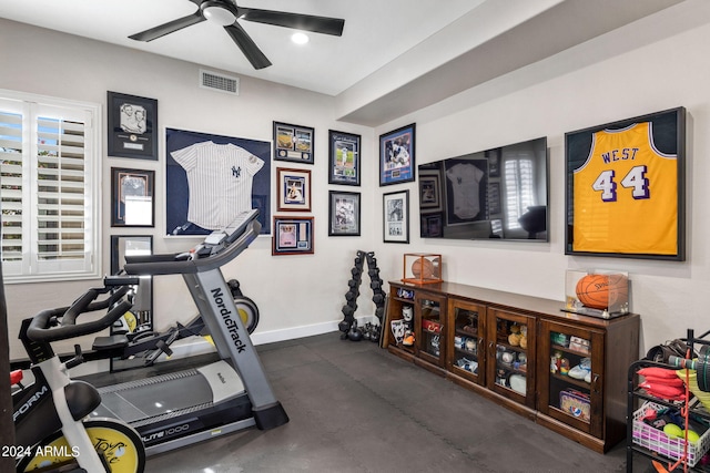 exercise area featuring baseboards, visible vents, and a ceiling fan