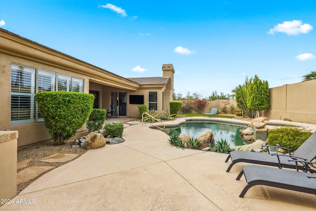 view of swimming pool with a fenced in pool, a fenced backyard, and a patio area
