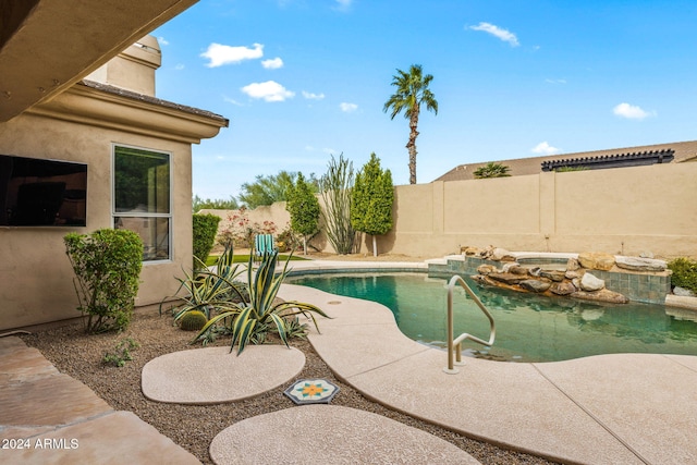 view of swimming pool featuring a fenced backyard, a hot tub, and a fenced in pool