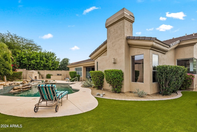 view of swimming pool with a patio, fence, a lawn, and a fenced in pool