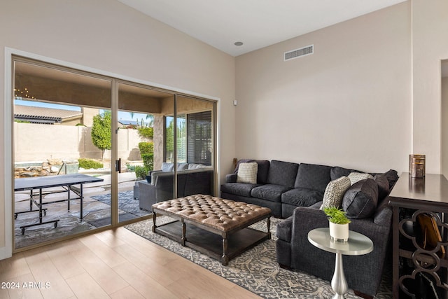 living room featuring light wood-style flooring and visible vents
