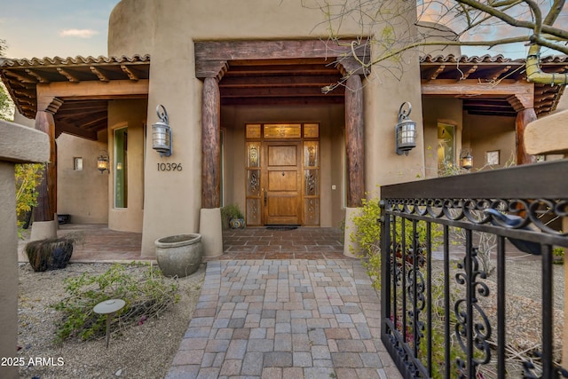 view of exterior entry at dusk