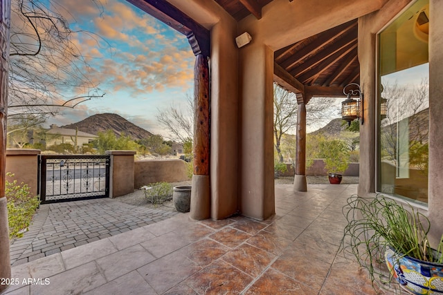 patio terrace at dusk featuring a mountain view