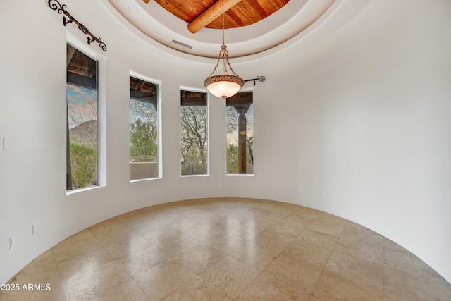 spare room featuring a raised ceiling and wooden ceiling