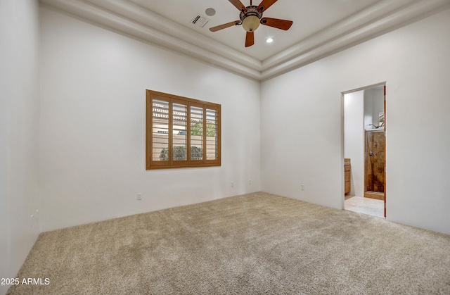 spare room with light colored carpet and ceiling fan