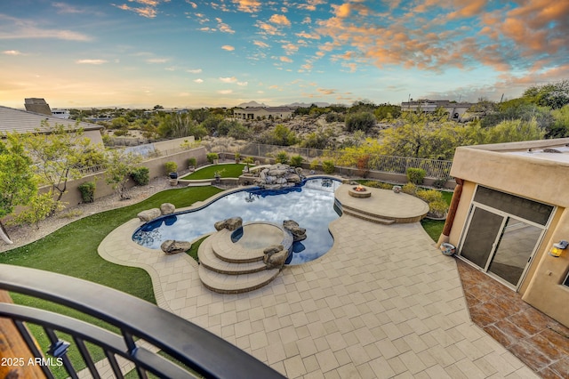 pool at dusk featuring a patio