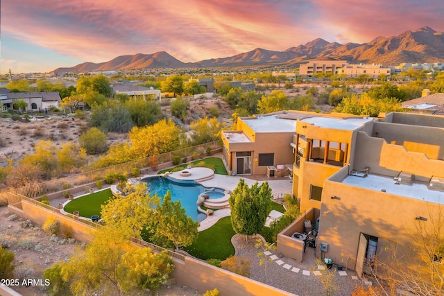 aerial view at dusk featuring a mountain view