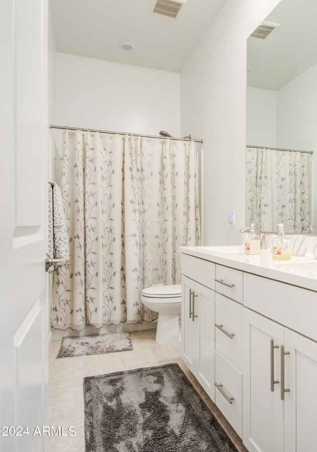 bathroom featuring vanity, toilet, tile patterned floors, and a shower with shower curtain