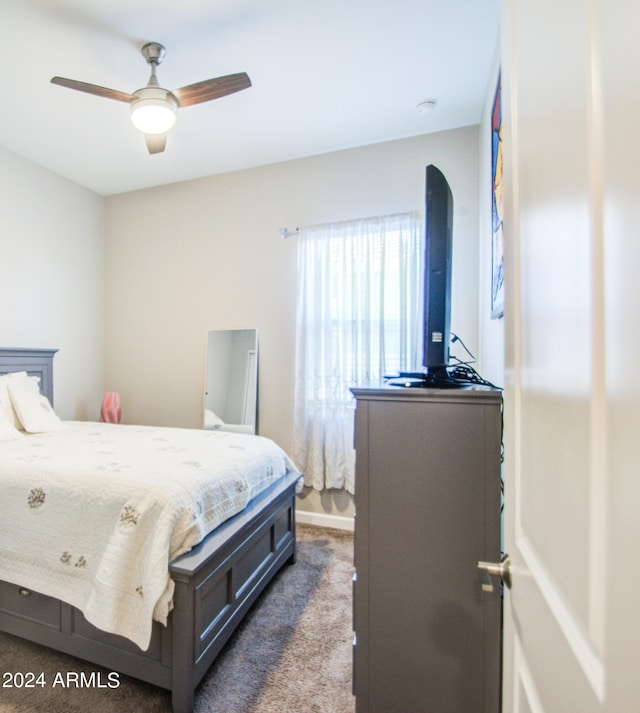 bedroom with ceiling fan and dark colored carpet